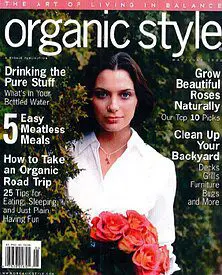 A woman holding flowers in her hands on the cover of organic style magazine.