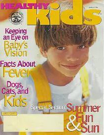 A magazine cover with a boy smiling for the camera.
