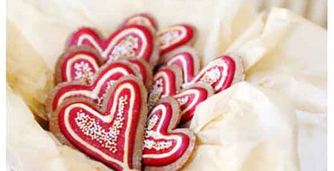 A close up of heart shaped cookies on a plate